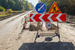 © Chmutphoto - A construction site on a country road with a set of road signs directing vehicles. Temporary road detour and speed limit zone due to ongoing construction works