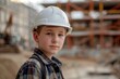 © darshika - Portrait of teenage boy wearing hardhat  standing in construction site and looking at camera.