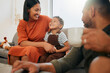 © Abrahams/peopleimages.com - Home, family and fun in living room with laughing mother and African kid together with bonding on sofa. Happy, weekend and father with love, support and care with youth and joke in lounge with joy
