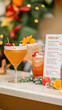 © ЮРИЙ ПОЗДНИКОВ - Three cocktails standing on bar with christmas decoration and menu in background