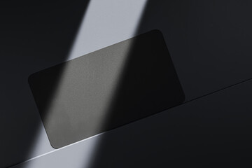 Close up of empty black business card on dark desk surface with sunlight. Ad concept. Mock up, 3D Rendering.