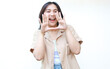 © M Alfan Setyawan - happy asian woman screaming with excitement wearing casual clothes isolated on white background, looking at camera