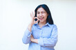 © M Alfan Setyawan - excited asian woman showing approval signs feeling satisfied wearing blue striped shirt standing over isolated white background