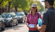 © Olga Nevskaya - Woman smiling while receiving charity donation on the street