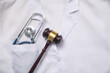 © andranik123 - Judge gavel with a stethoscope on doctor clothes.