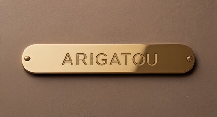 arigatou engraved text on gold name plate sign 