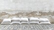 © VRVisionary - White sandbags arranged in a neat row against a plain wall on a stone floor serving as flood protection barriers Ample copy space available