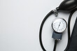 © New Africa - Blood pressure measuring device on light grey background, top view. Space for text