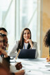 © Jacob Lund - Confident female professional leading a vibrant marketing group discussion in a modern office setting with diverse participants engaged in collaborative strategies and ideas.