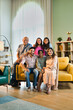 © StockImageFactory - Closeup of Indian family of six sitting together on a sofa in a lavish home, joyful moments