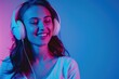 © Vii - A young woman wearing headphones smiles directly at the camera, conveying confidence and happiness