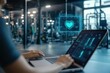 © gankevstock - A person working on a laptop in a gym with a heart icon hologram