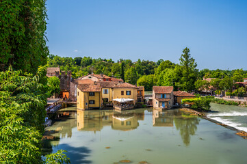 Wall Mural - Summer on the Mincio river. Historic village of Borghetto sul Mincio