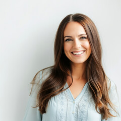 A young woman with a happy expression, wearing a white blouse