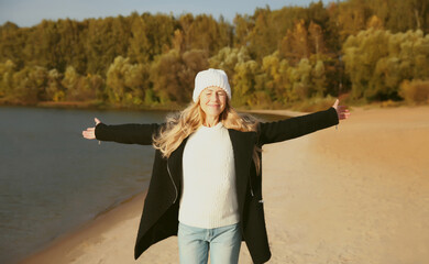 Wall Mural - Happy smiling woman on sunny beach, joyful girl enjoying landscape, warm weather on sea coast