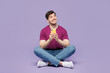 © ViDi Studio - Full body young smiling man he wear violet t-shirt casual clothes sit hold in hand use mobile cell phone look aside isolated on plain pastel light purple background studio portrait. Lifestyle concept.