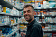 © Tetiana - Photo of pharmacist stands in medical robe smiling in pharmacy shop full of medicines generative AI