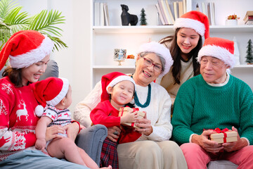 Wall Mural - Father, mother and little boy celebrating Christmas with family.