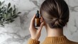 © รุ่งอรุณ ศรีนรสิทธิ์ - Woman Applying Nourishing Hair Treatment from Back View