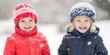 © Kamonwan - Two happy children in winter hats playing in the snow, cheerful atmosphere.