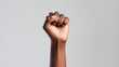 © Iuliia Pilipeichenko - Close-Up of Raised Black Woman's Fist in Studio Shot. Woman hand. Black History. African American female