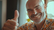 © MariAnnaCreative - Man showing thumbs-up and smiling happily indoors