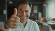 © MariAnnaCreative - Man showing thumbs-up and smiling happily indoors
