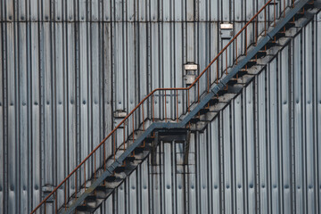 Metal staircase swirling around a storage tank