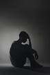 © Armir - Silhouette of a Person Sitting with Head in Hands.