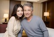 © KS CREATE - 年の差婚をした夫婦がホテルの客室で微笑んでいる