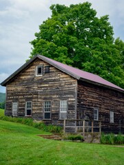 Rustic barn in a rural setting with weathered wood and a scenic backdrop