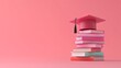 © Stanley - A stack of books topped with a graduation cap on a pink background celebrates academic achievement and educational milestones