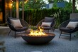© Alexandra - Fire pit is burning during the summer evening with designers relaxing in chairs around it