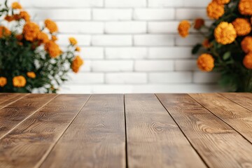 Poster - Empty wooden table with blurred cempasuchil flowers with white brick wall background.
