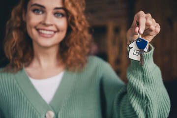 Photo of shiny cute woman dressed green cardigan rising keys indoors house apartment room