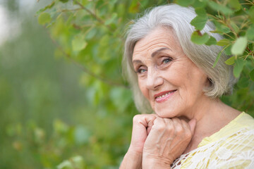 Wall Mural - Portrait of a beautiful elderly woman in the park