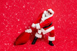 © deagreez - Full body photo of unhappy crazy having hipster style funny Santa in fur coat trousers boots cuffs dragging large bag full of different giftboxes for children isolated bright background