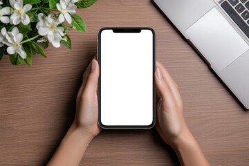 Poster - A person holding a smartphone with a blank white screen, with a laptop and a potted plant in the background.