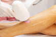 © Irina Mikhailichenko - Diode laser epilation hair removal procedure on a woman leg. Beautician doing laser rejuvenation in a beauty salon. Removing unwanted body hair. Hardware cosmetology. High quality photo