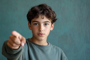 A young boy looking directly at the camera with an inquisitive expression