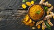 © MahmudulHassan - Turmeric powder and fresh turmeric roots on wooden background, top view