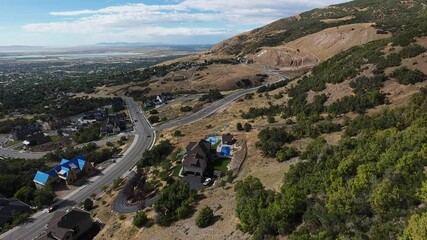 Wall Mural - Bountiful city with luxurious houses, winding roads and lush greens, under a blue sky in Utah, USA