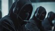 © Johannes - Call center scammer concept. Swindler criminals in black hood wearing mask and headsets and using computer in a call center office.