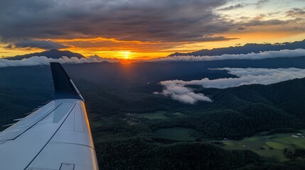 Poster - A breathtaking sunset view from an airplane window as the sun sets over a mountain range.