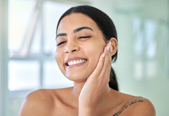 Hand, skincare and smile with face of woman in bathroom of home for morning beauty routine. Cleaning, hygiene and grooming with happy person in apartment for satisfaction of facial dermatology