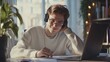 © Johannes - Smiling young Caucasian man in headphones glasses sit at desk work on laptop making notes. Happy millennial male in earphones watch webinar or training course or computer, study online from home.
