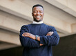 © peopleimages.com - Happy, crossed arms and portrait of businessman in city with pride for finance capital gain. Travel, smile and African male financial advisor from Nigeria with confidence for career in urban town.