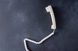 © Real_life - Telephone handset with cord. Old Phone. Black background copy space.