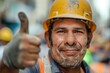 © Vii - A construction worker wearing a hard hat gives a thumbs up, indicating approval or satisfaction