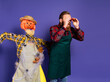 © deagreez - Photo of shocked surprised man scary traditional scarecrow watching binoculars fall season sale isolated on purple color background